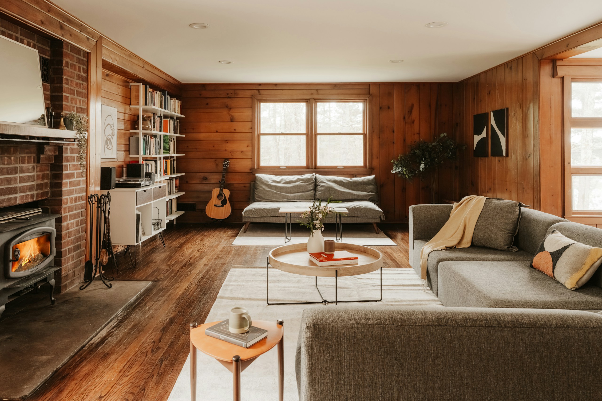 A warm, wood-panelled short-term rental living room